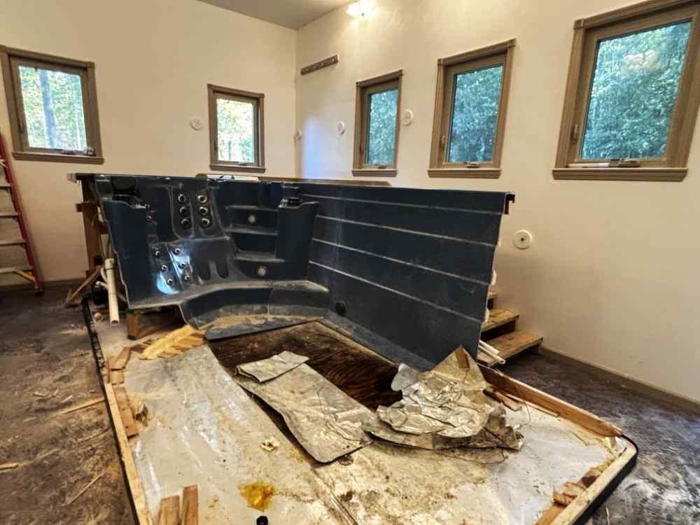 Indoor hot tub removal and residential demolition in progress.