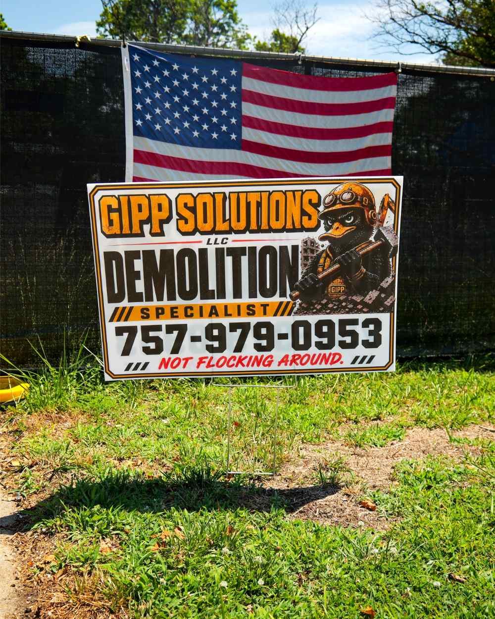Gipp Solutions LLC Demolition Specialist job site sign with contact phone number and American flag.