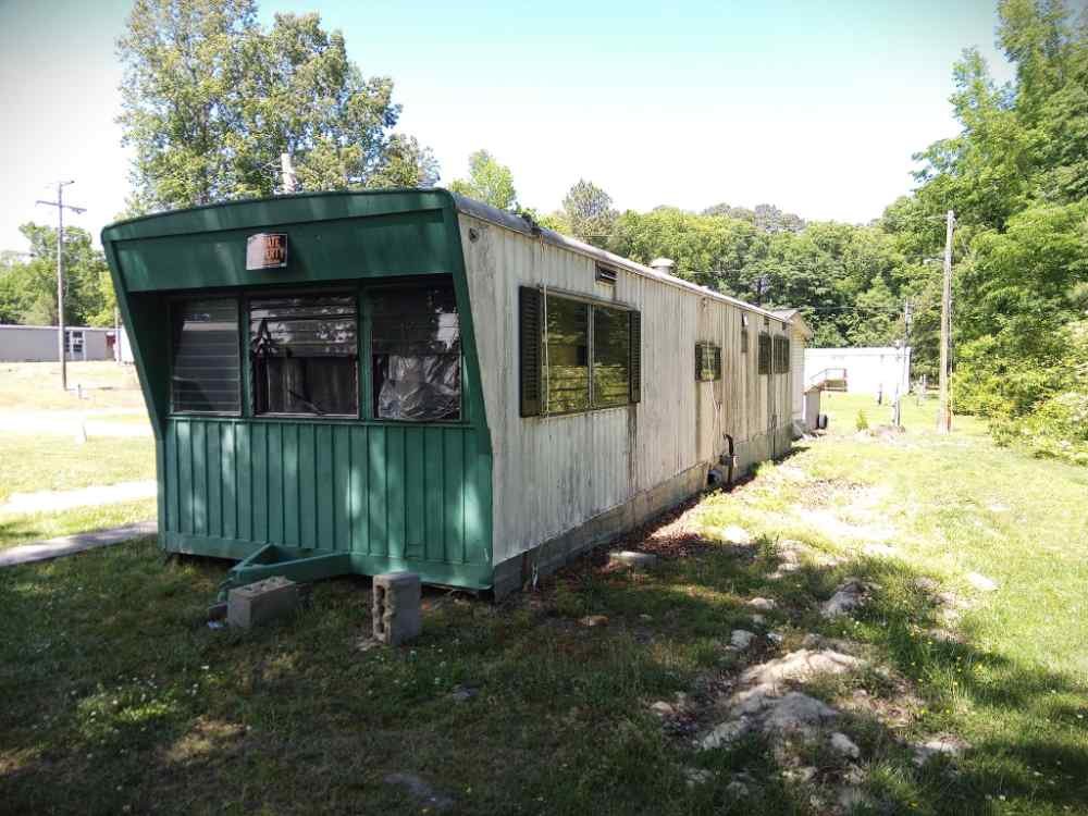 Older mobile home slated for residential teardown and removal services.