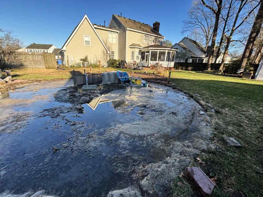 Residential backyard swimming pool demolition and site clearing in progress.