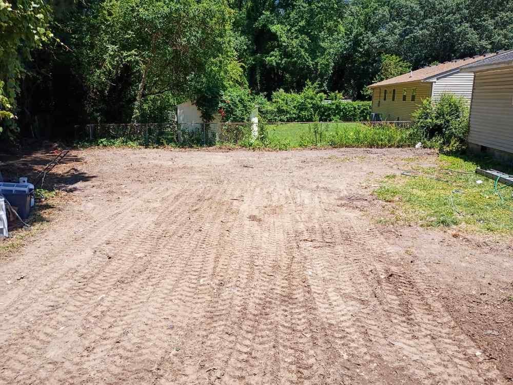 Residential backyard after complete site clearing and grading by demolition contractors.