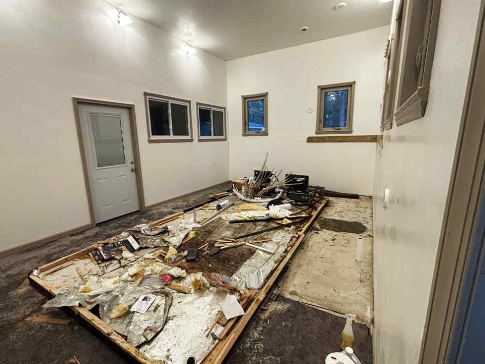 Interior commercial demolition showing exposed framing and debris during a gut renovation project.