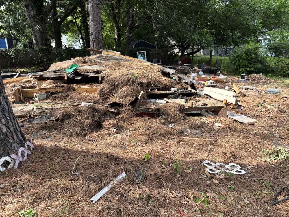 Debris pile and structural remnants on a residential demolition and site clearing project.
