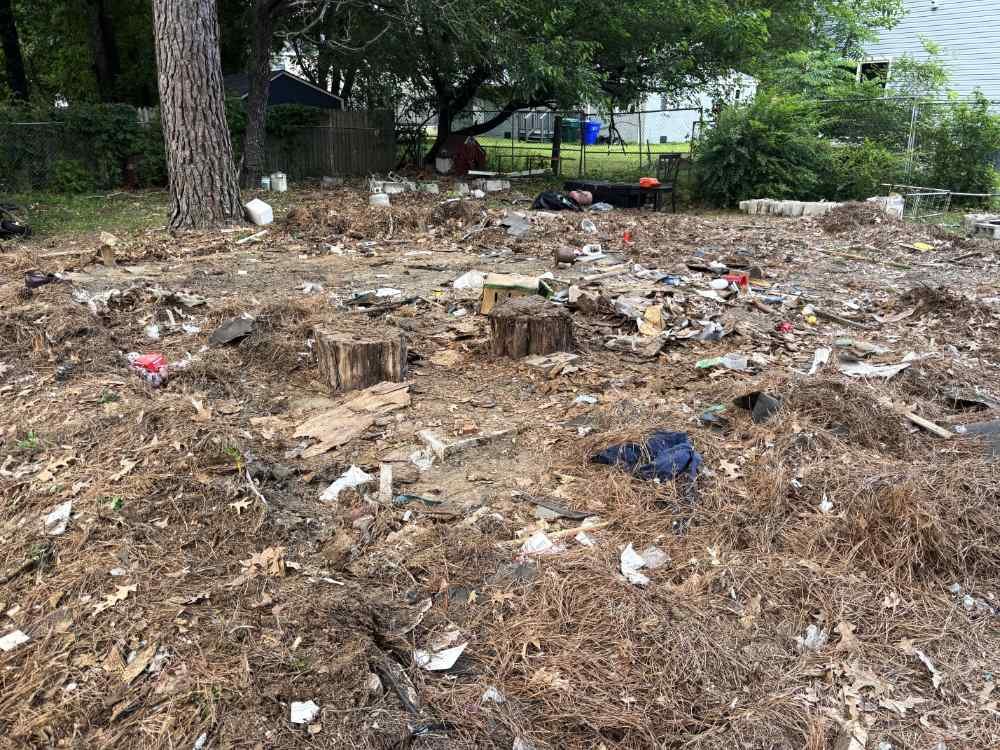 Residential site clearing and debris pile after structure demolition.
